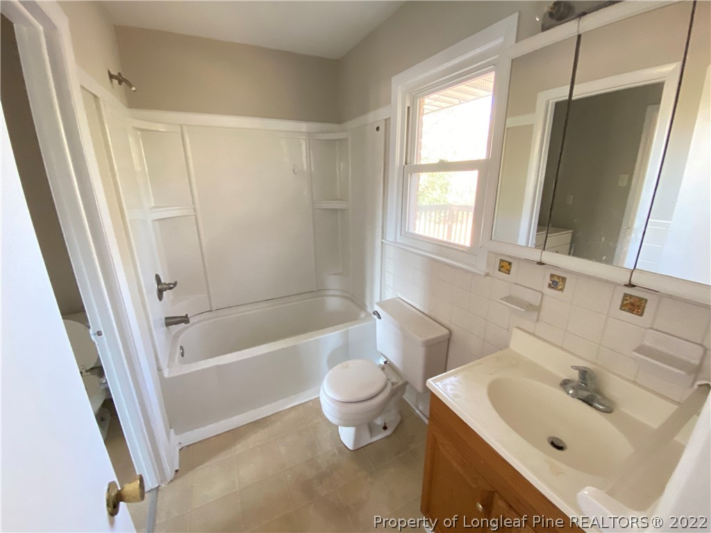 3518 Drayton Road Fayetteville, NC 28303 - Photo 14 of 17 a bathroom with a sink toilet and shower