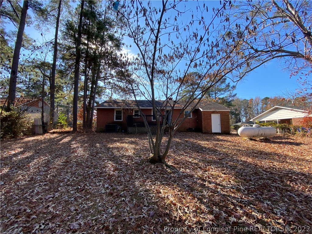 3518 Drayton Road Fayetteville, NC 28303 - Photo 17 of 17 a view of a house with backyard that has a tree
