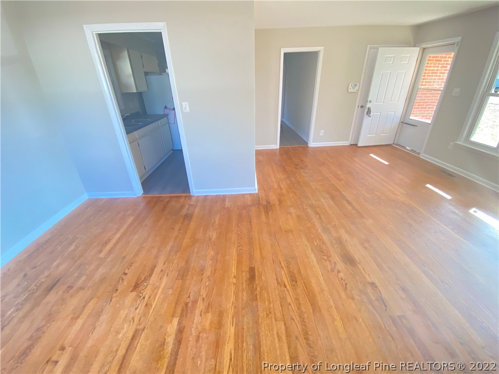 3518 Drayton Road Fayetteville, NC 28303 - Photo 5 of 17 a view of a hallway with wooden floor and staircase