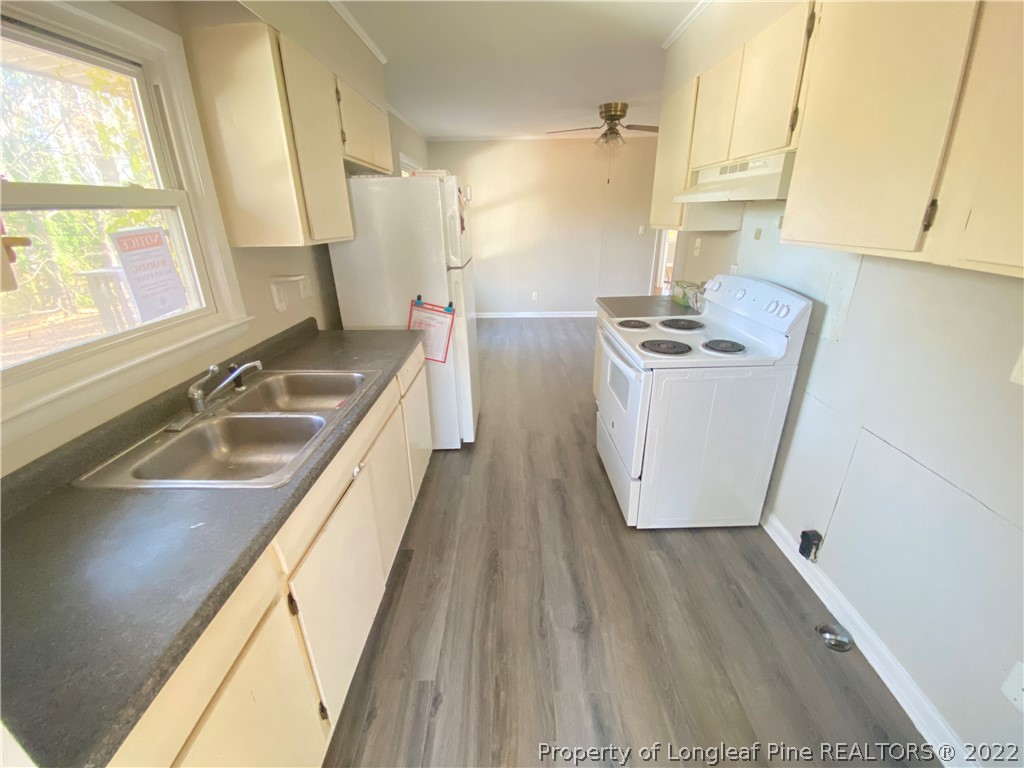 3518 Drayton Road Fayetteville, NC 28303 - Photo 6 of 17 a kitchen with sink cabinets and wooden floor