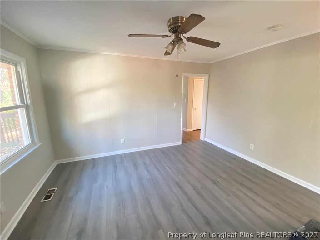 3518 Drayton Road Fayetteville, NC 28303 - Photo 7 of 17 wooden floor in an empty room with a window