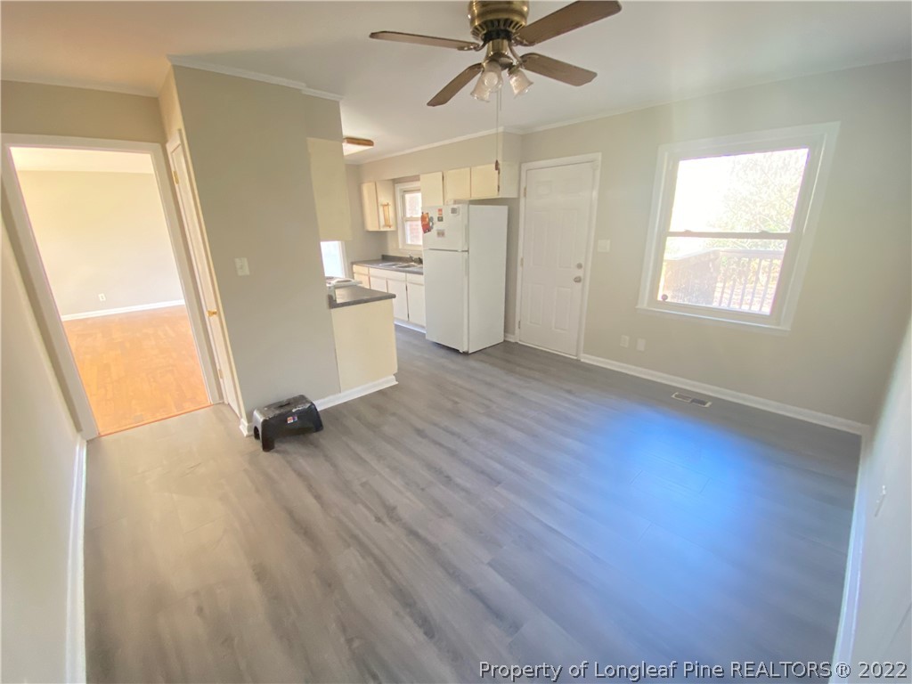 3518 Drayton Road Fayetteville, NC 28303 - Photo 9 of 17 wooden floor in an empty room with a window
