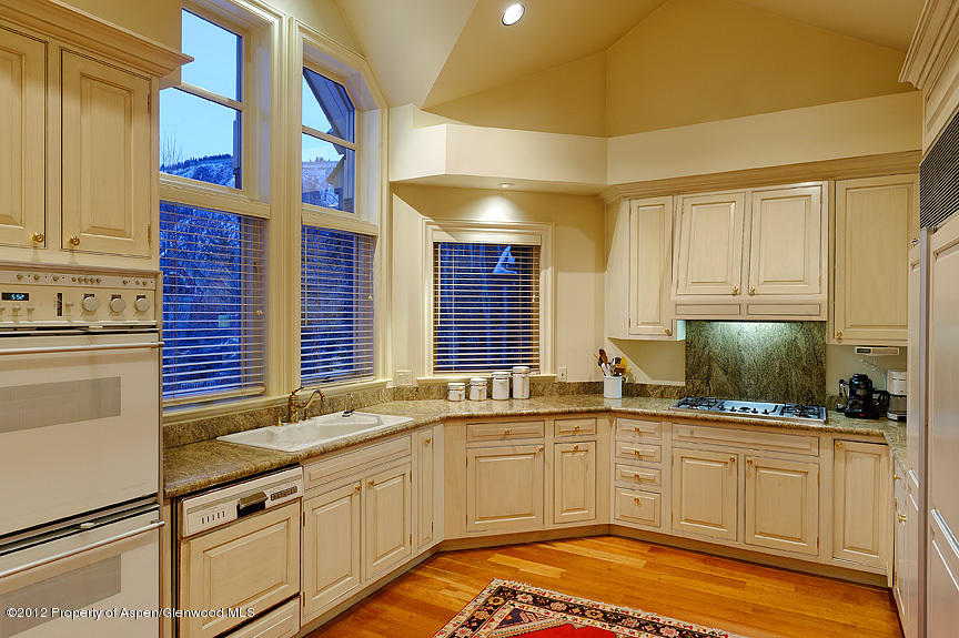 102 North Spring Street, Unit #2 Aspen, CO 81611 - Photo 6 of 18 a kitchen with stainless steel appliances granite countertop a sink and cabinets