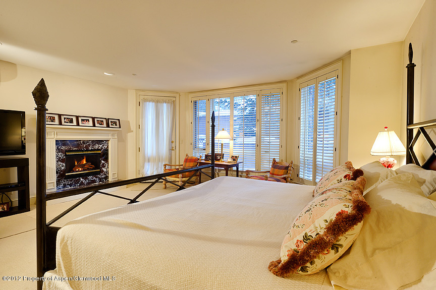 102 North Spring Street, Unit #2 Aspen, CO 81611 - Photo 8 of 18 a spacious bedroom with a bed and a large window