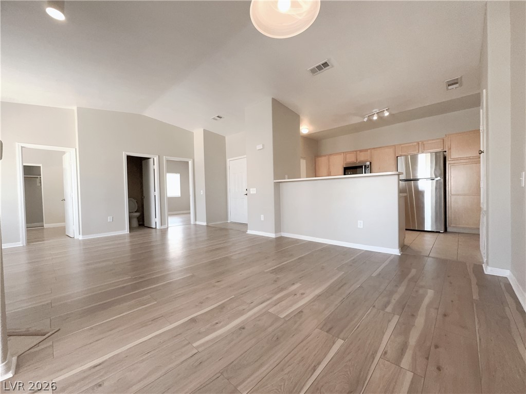 8725 West Flamingo Road, Unit 208 Las Vegas, NV 89147 - Photo 6 of 16 This bright, open-concept living space features warm flooring and a modern kitchen.