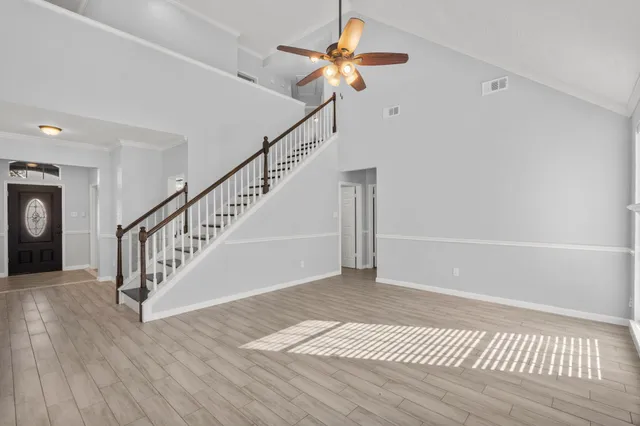 a view of entryway and hall with wooden floor