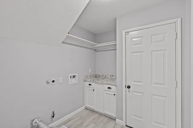 a view of storage and utility room with wooden floor
