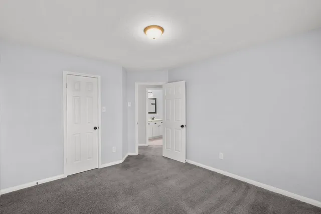 a bathroom with a granite countertop bathtub sink vanity mirror and toilet