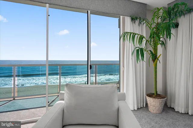 a kitchen with stainless steel appliances kitchen island granite countertop a refrigerator a sink a stove and white cabinets with wooden floor