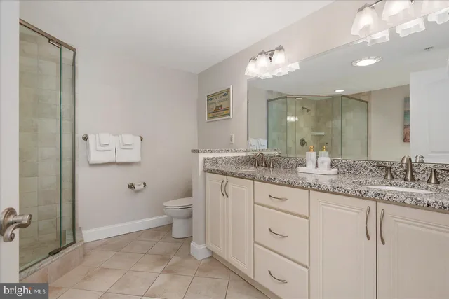 a kitchen with stainless steel appliances granite countertop table chairs and a refrigerator