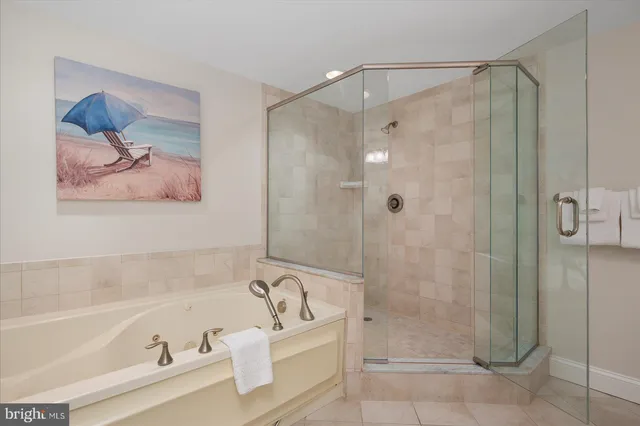 a living room with couches and kitchen view with wooden floor