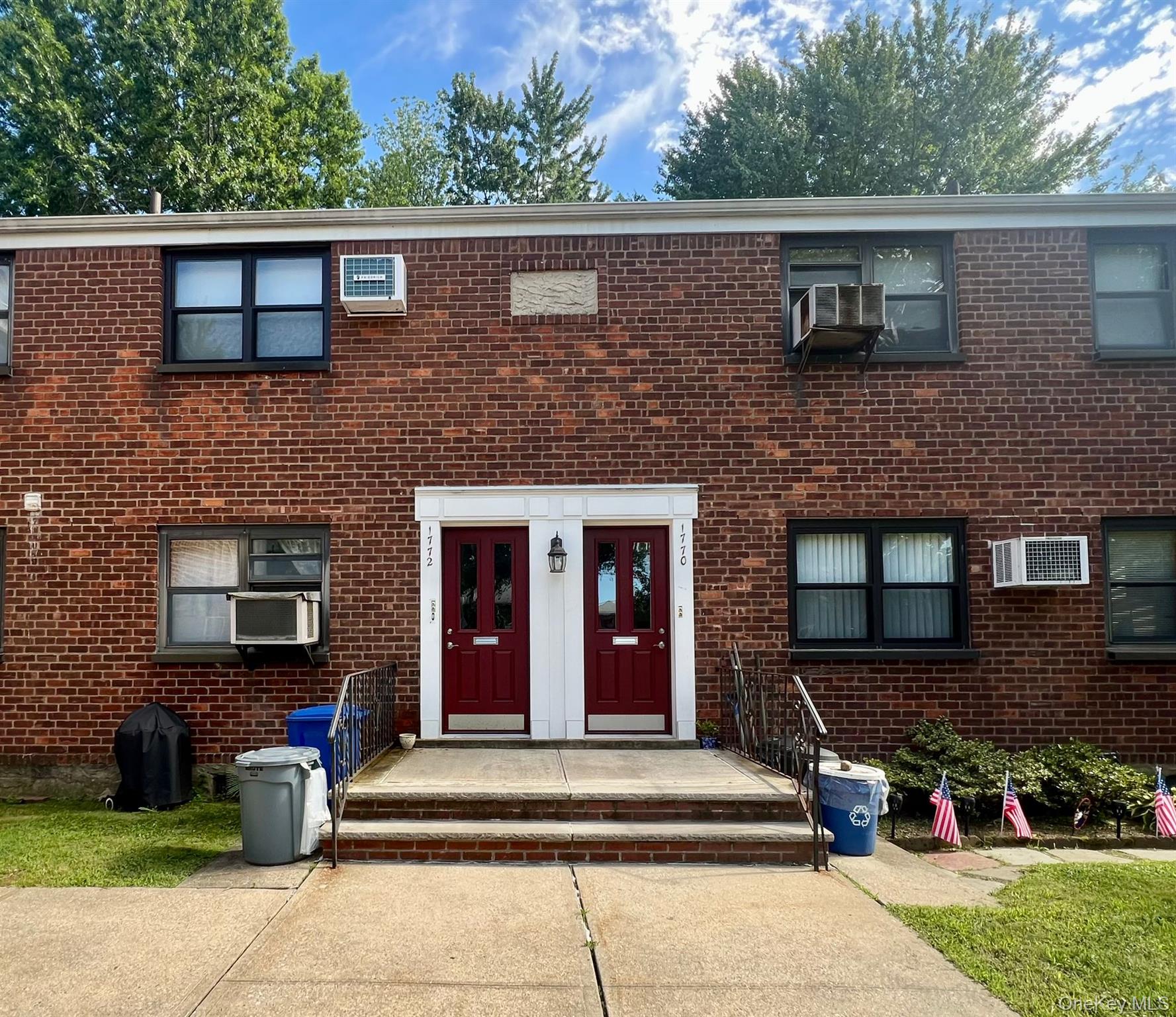a front view of a house with outdoor seating and plants