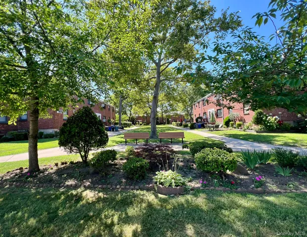 a view of yard with swimming pool and green space