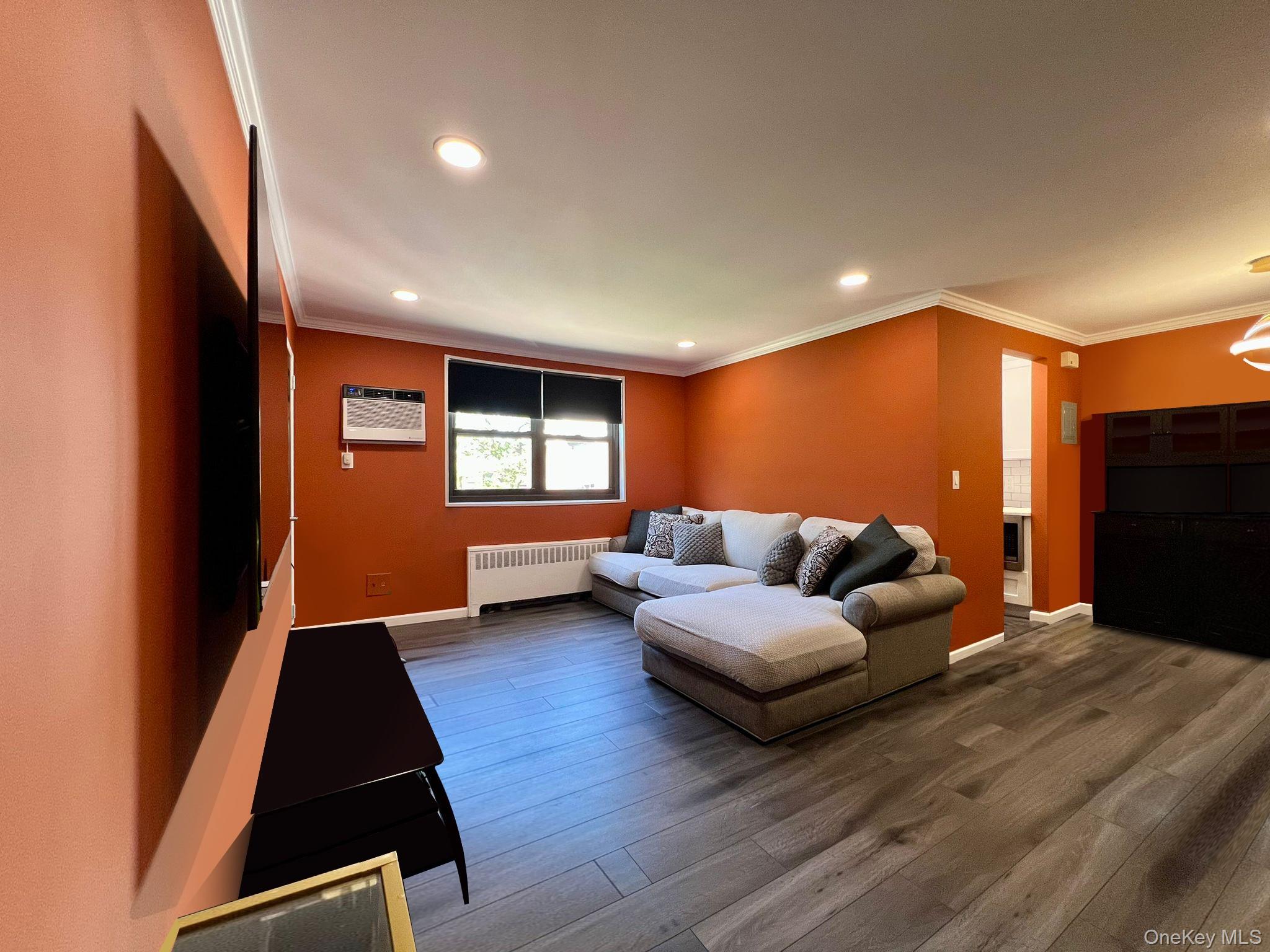 17-72 166th Street, Unit 2 Queens, NY 11357 - Photo 2 of 13 a living room with furniture and a flat screen tv