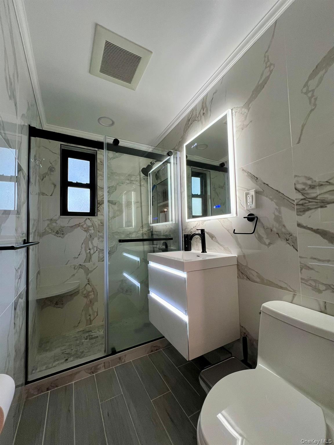 17-72 166th Street, Unit 2 Queens, NY 11357 - Photo 6 of 13 a bathroom with a toilet a sink and shower