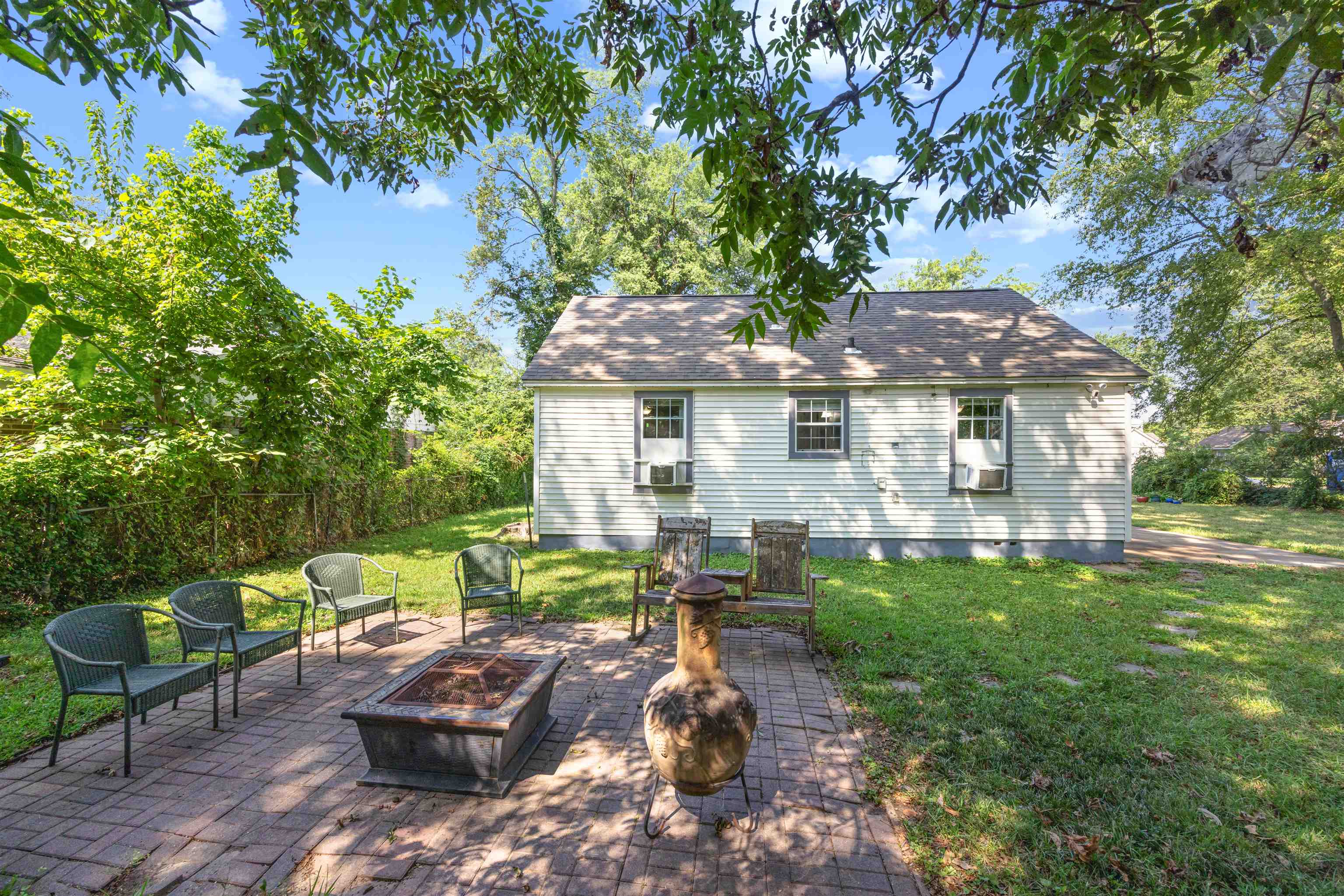 3014 Benjestown Road Memphis, TN 38127 - Photo 12 of 15 Rear view of house with a patio, a fire pit, and a yard