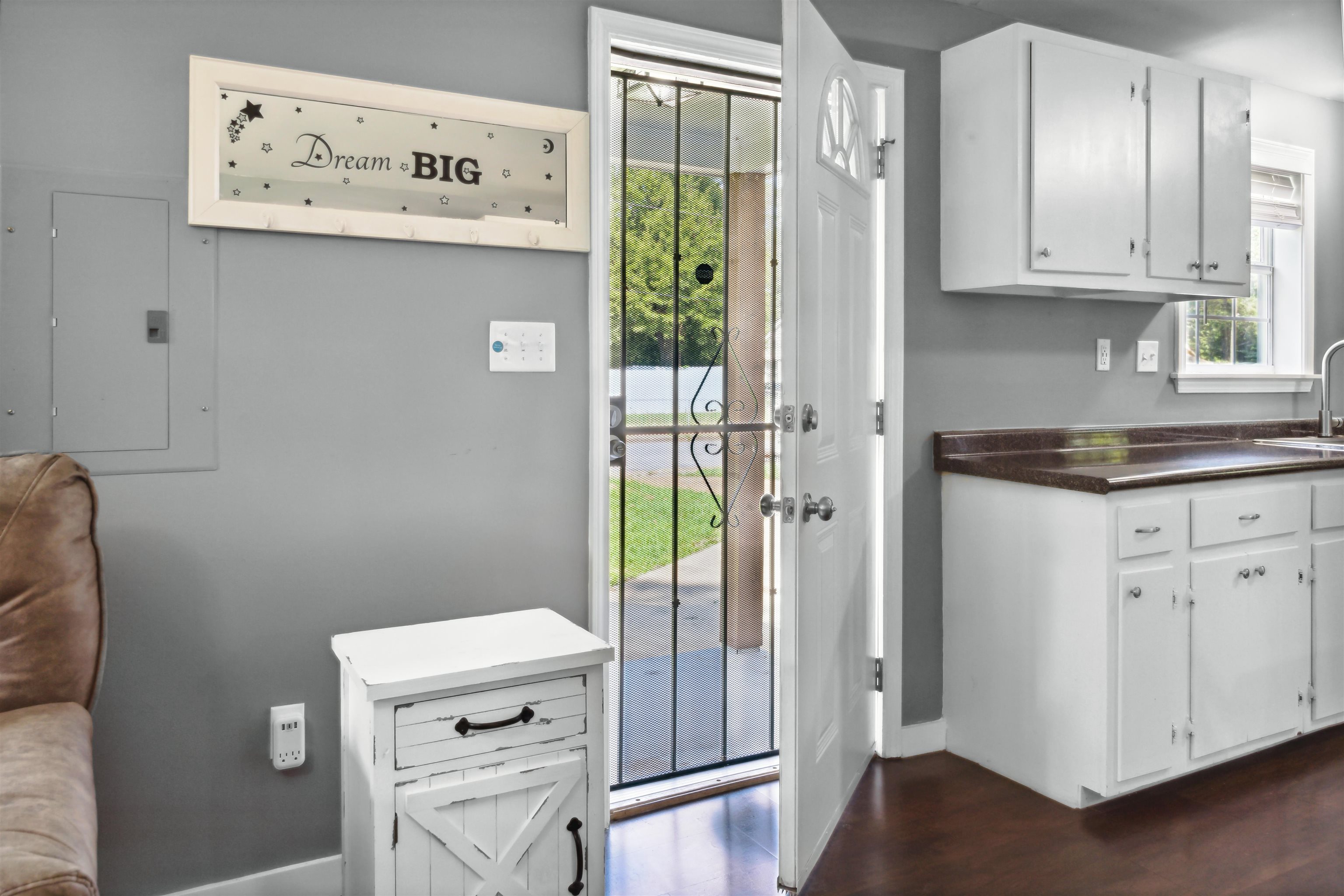 3014 Benjestown Road Memphis, TN 38127 - Photo 8 of 15 Doorway to outside featuring sink, electric panel, and dark hardwood / wood-style flooring