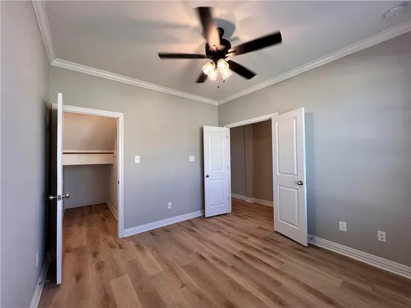 a view of an empty room and wooden floor