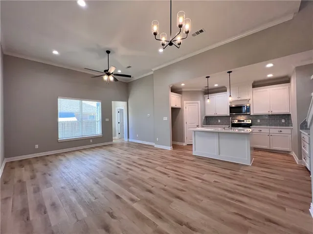 a view of kitchen with sink and refrigerator