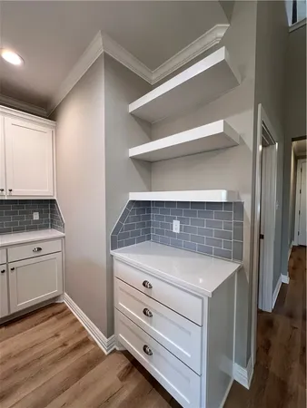a view of kitchen cabinets and wooden floor