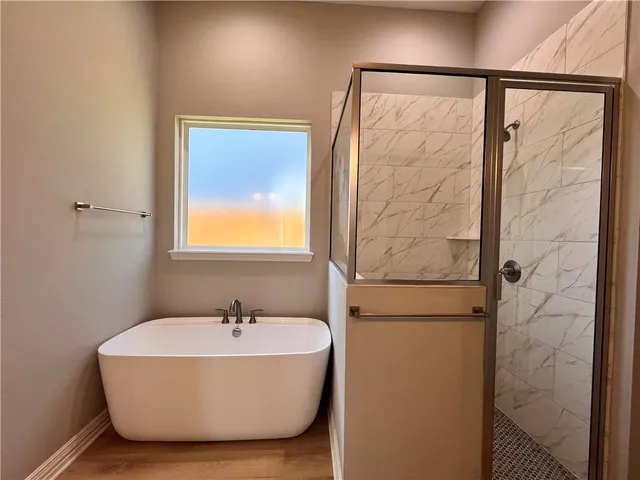 a bathroom with a bathtub and a shower