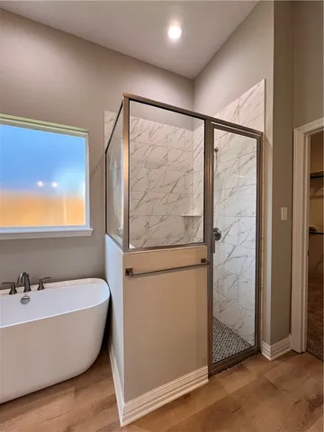 a bathroom with a bathtub and shower