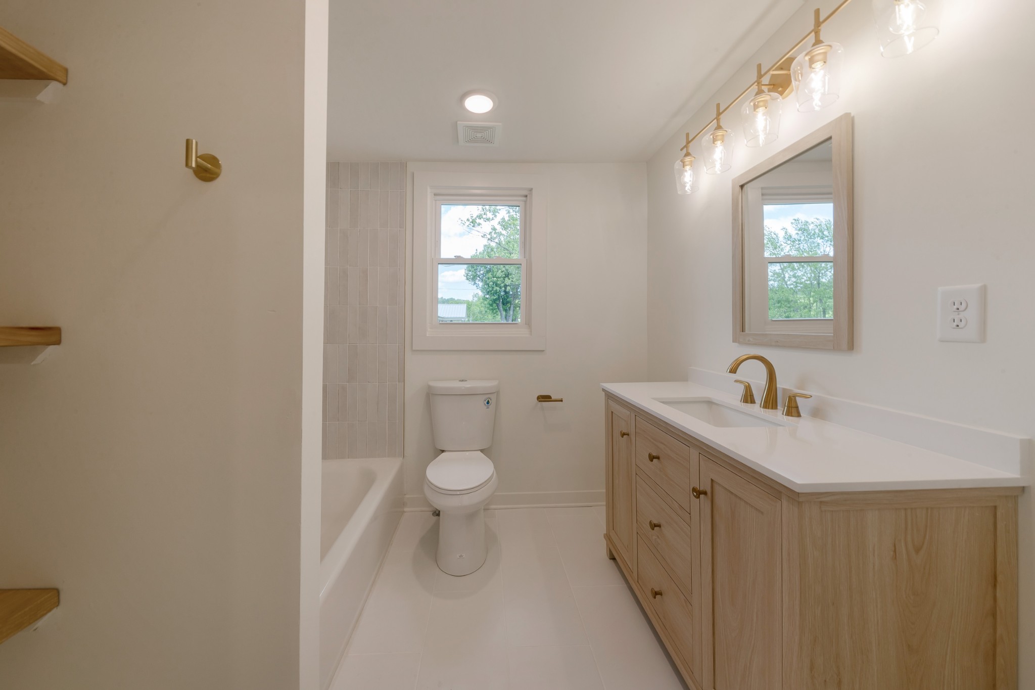 2727 Fly Road Santa Fe, TN 38482 - Photo 11 of 21 a bathroom with a granite countertop sink a toilet and a window