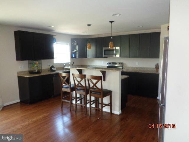 359 Boise Road Inwood, WV 25428 - Photo 3 of 22 a view of a dining room with furniture and wooden floor