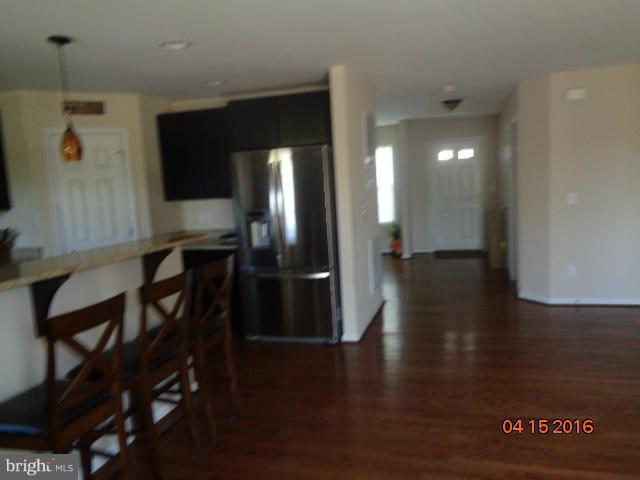 359 Boise Road Inwood, WV 25428 - Photo 8 of 22 a view of a hallway to an empty room with wooden floor and a cabinet