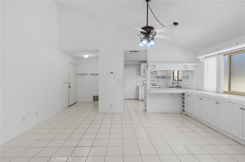 29368 Murrieta Road Menifee, CA 92586 - Photo 3 of 20 a view of a kitchen with cabinet and a refrigerator
