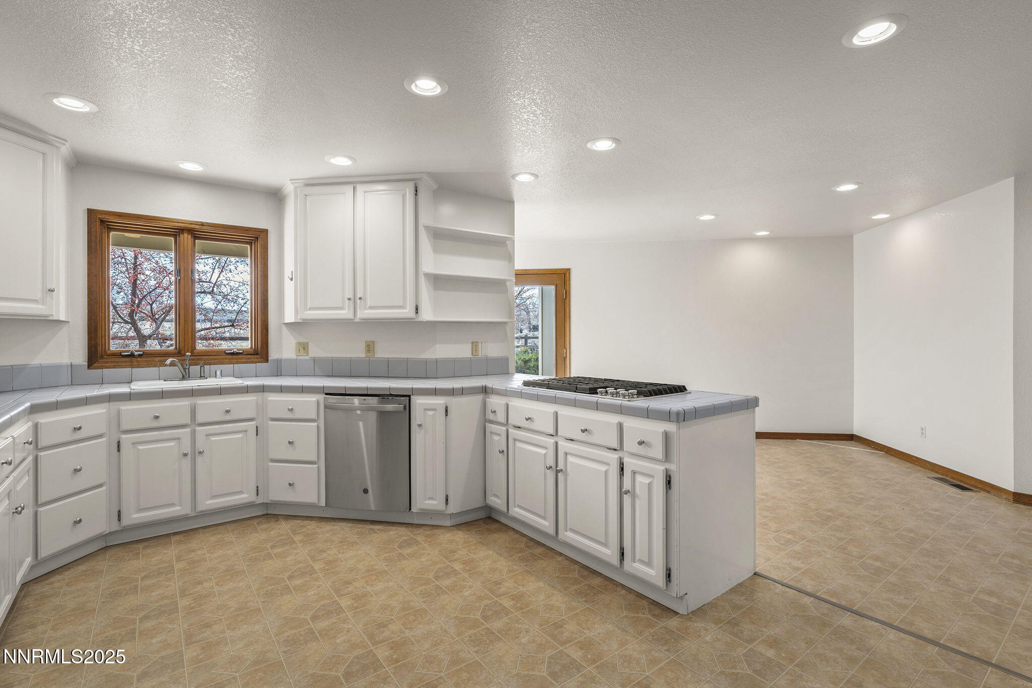 1653 Dees Lane Minden, NV 89423 - Photo 11 of 36 a kitchen with stainless steel appliances granite countertop a stove a sink and a refrigerator