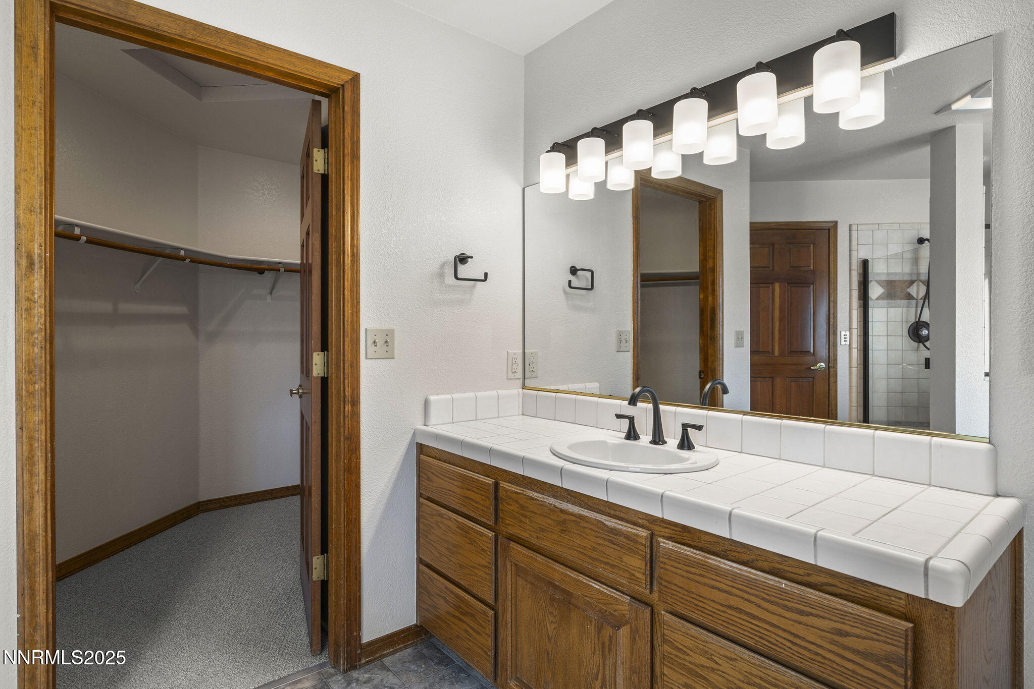 1653 Dees Lane Minden, NV 89423 - Photo 16 of 36 a bathroom with a sink and a mirror