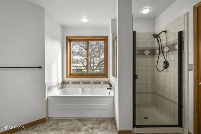 a bathroom with a shower sink and mirror