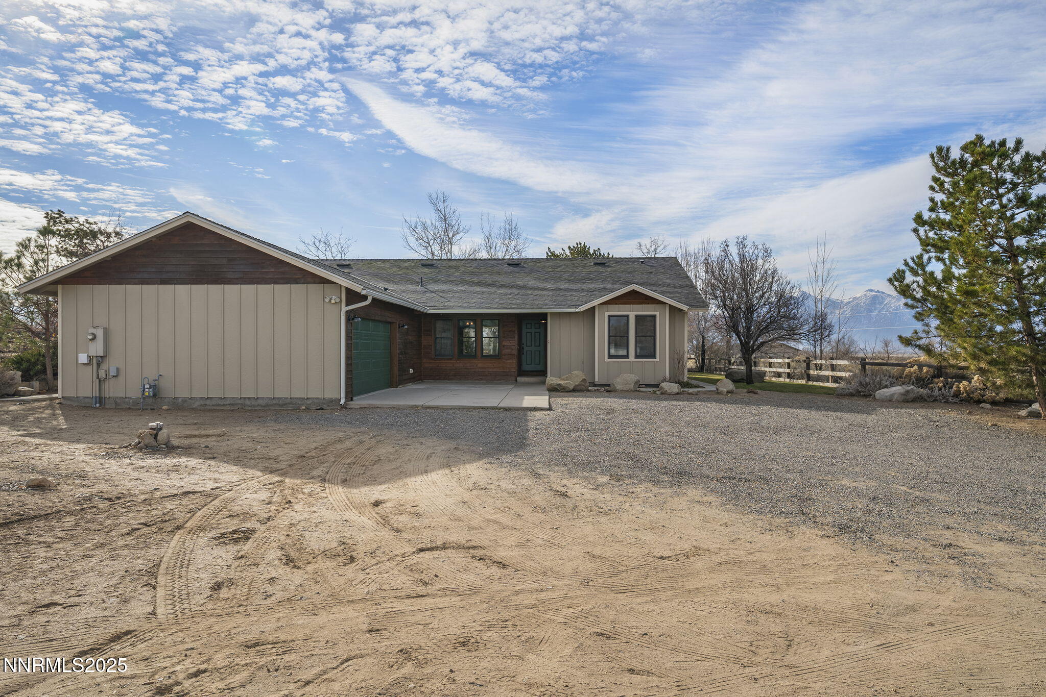 1653 Dees Lane Minden, NV 89423 - Photo 4 of 36 a front view of a house with a yard and garage