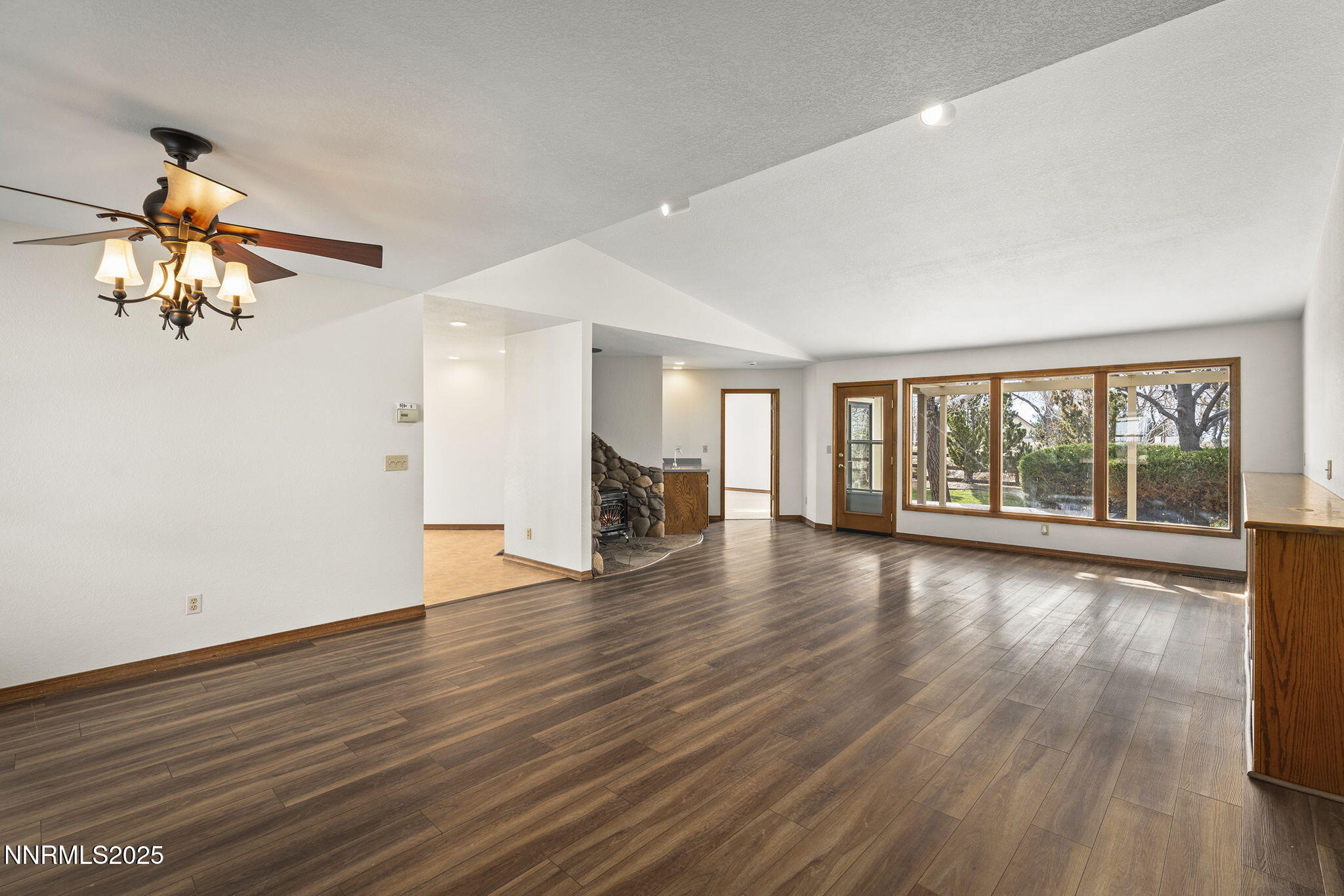 1653 Dees Lane Minden, NV 89423 - Photo 5 of 36 a view of an empty room with wooden floor and a window