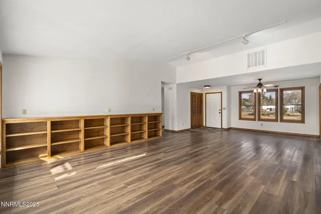 wooden floor in an empty room with wooden floor and windows