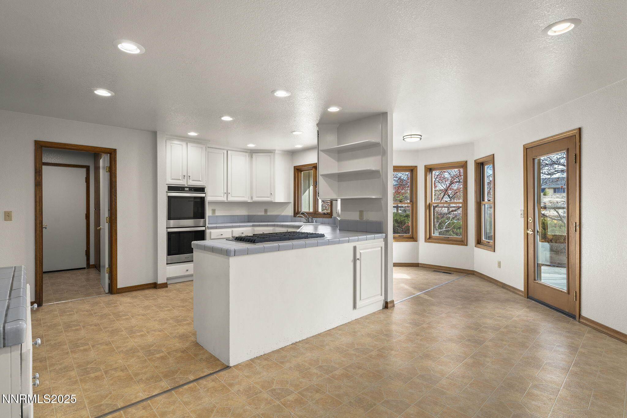 1653 Dees Lane Minden, NV 89423 - Photo 10 of 36 a large kitchen with stainless steel appliances kitchen island granite countertop a refrigerator and a stove top oven