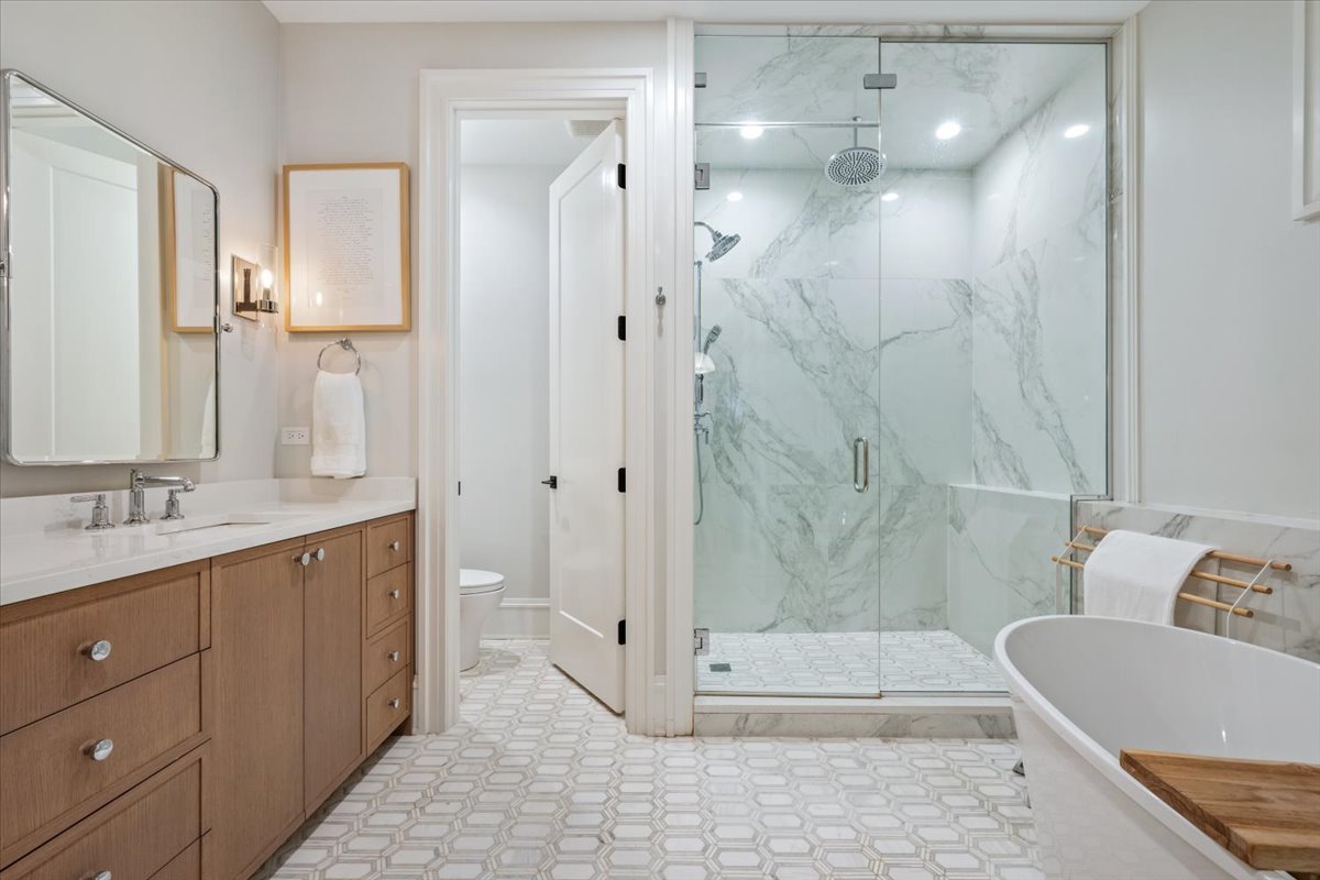 2212 North Halsted Street, Unit 1 Chicago, IL 60614 - Photo 20 of 38 a bathroom with a double vanity sink toilet and shower