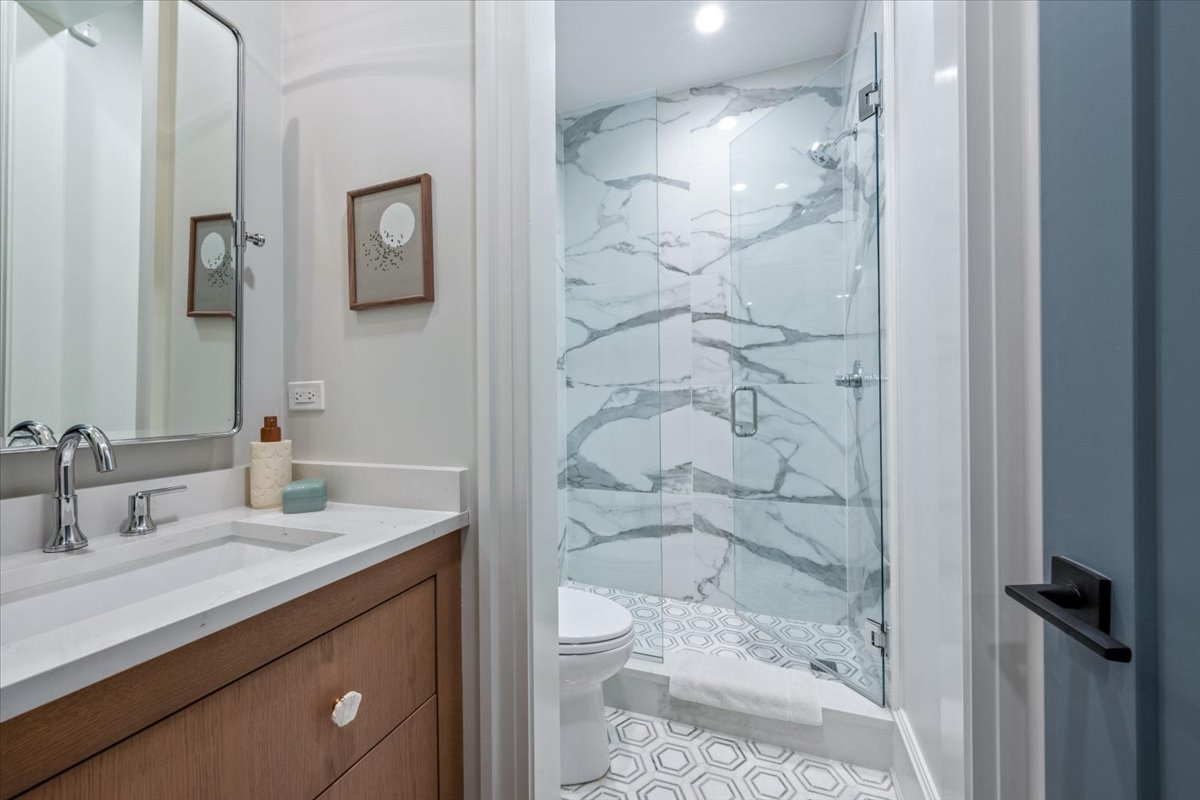 2212 North Halsted Street, Unit 1 Chicago, IL 60614 - Photo 31 of 38 a bathroom with a granite countertop sink toilet and shower