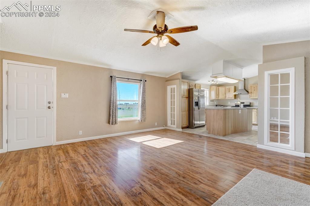 6240 Night Train Lane Yoder, CO 80864 - Photo 11 of 50 a view of an empty room with wooden floor and a window