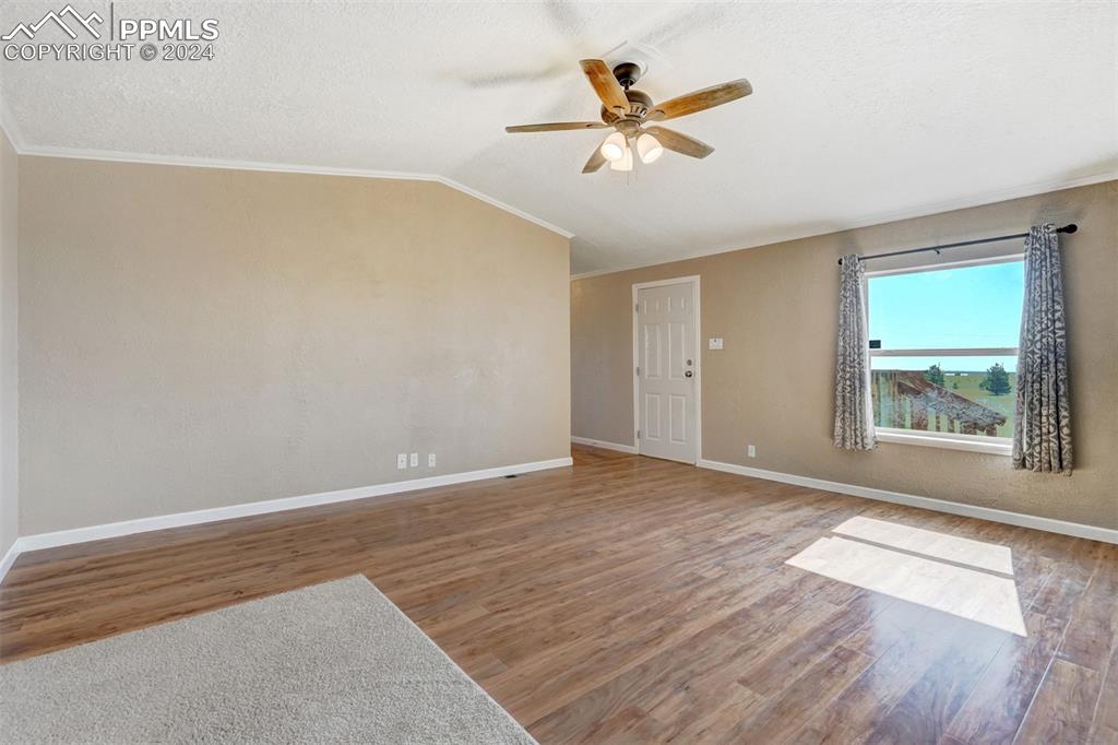 6240 Night Train Lane Yoder, CO 80864 - Photo 12 of 50 wooden floor in an empty room with a window