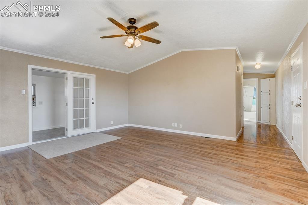 6240 Night Train Lane Yoder, CO 80864 - Photo 13 of 50 a view of a big room with wooden floor and a chandelier fan