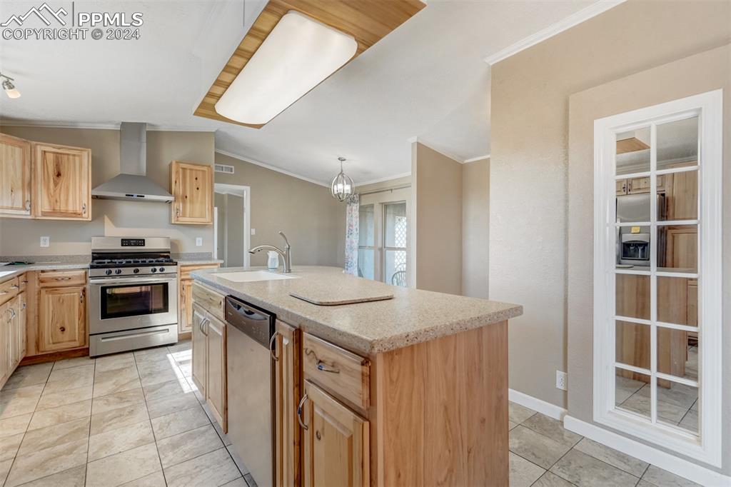 6240 Night Train Lane Yoder, CO 80864 - Photo 15 of 50 a kitchen with stainless steel appliances granite countertop a stove and a sink