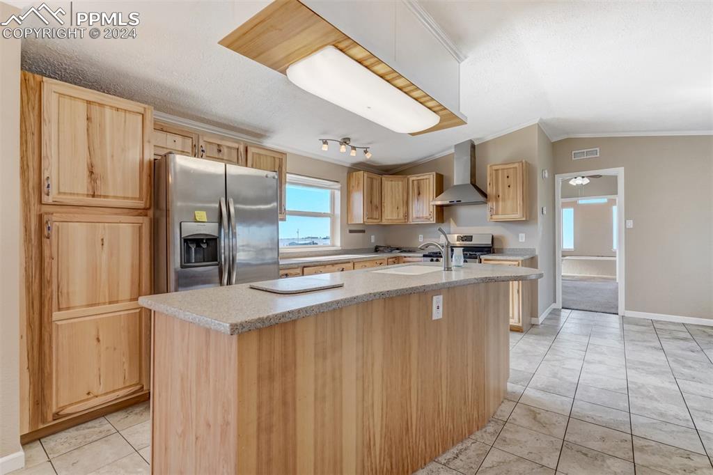 6240 Night Train Lane Yoder, CO 80864 - Photo 16 of 50 a kitchen with stainless steel appliances granite countertop a refrigerator a stove and a sink