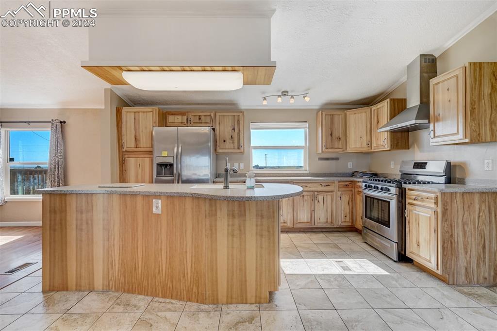 6240 Night Train Lane Yoder, CO 80864 - Photo 17 of 50 a kitchen with a stove a sink and a refrigerator