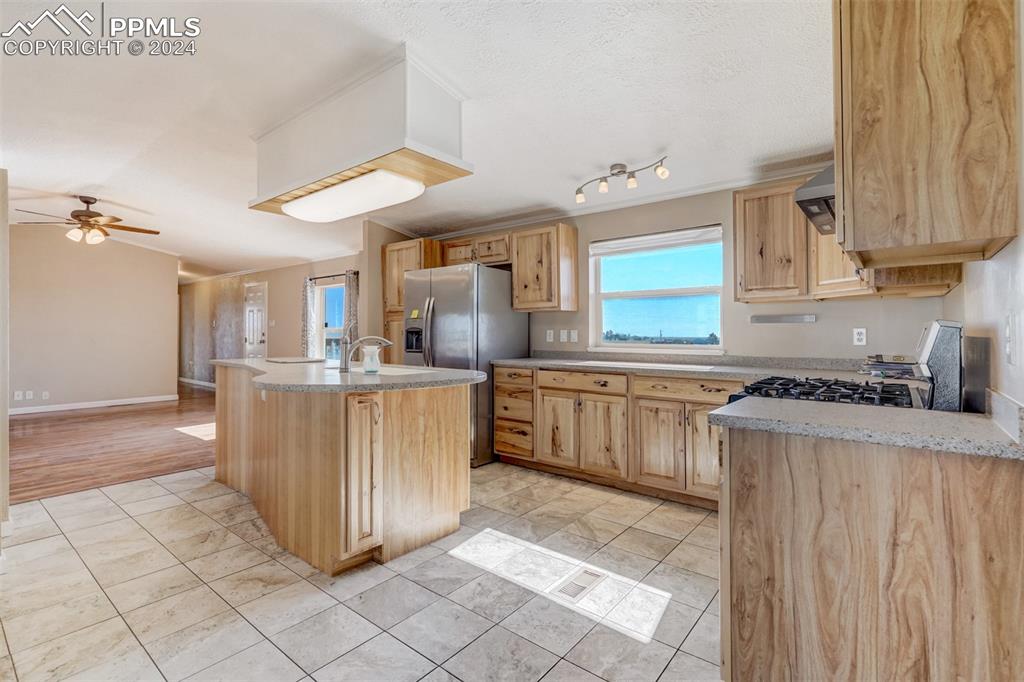 6240 Night Train Lane Yoder, CO 80864 - Photo 18 of 50 a kitchen with a stove a sink and a refrigerator