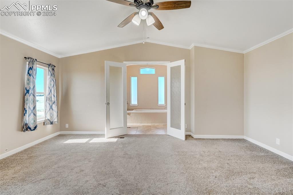 6240 Night Train Lane Yoder, CO 80864 - Photo 28 of 50 an empty room with windows and fan