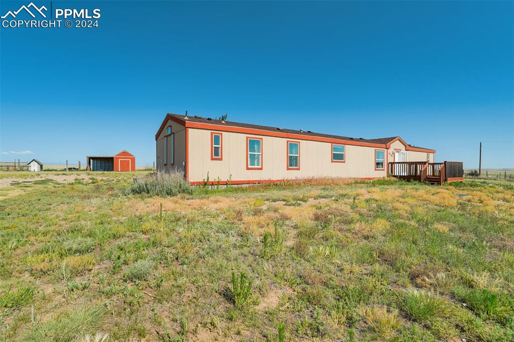 6240 Night Train Lane Yoder, CO 80864 - Photo 3 of 50 a view of a house with a big yard