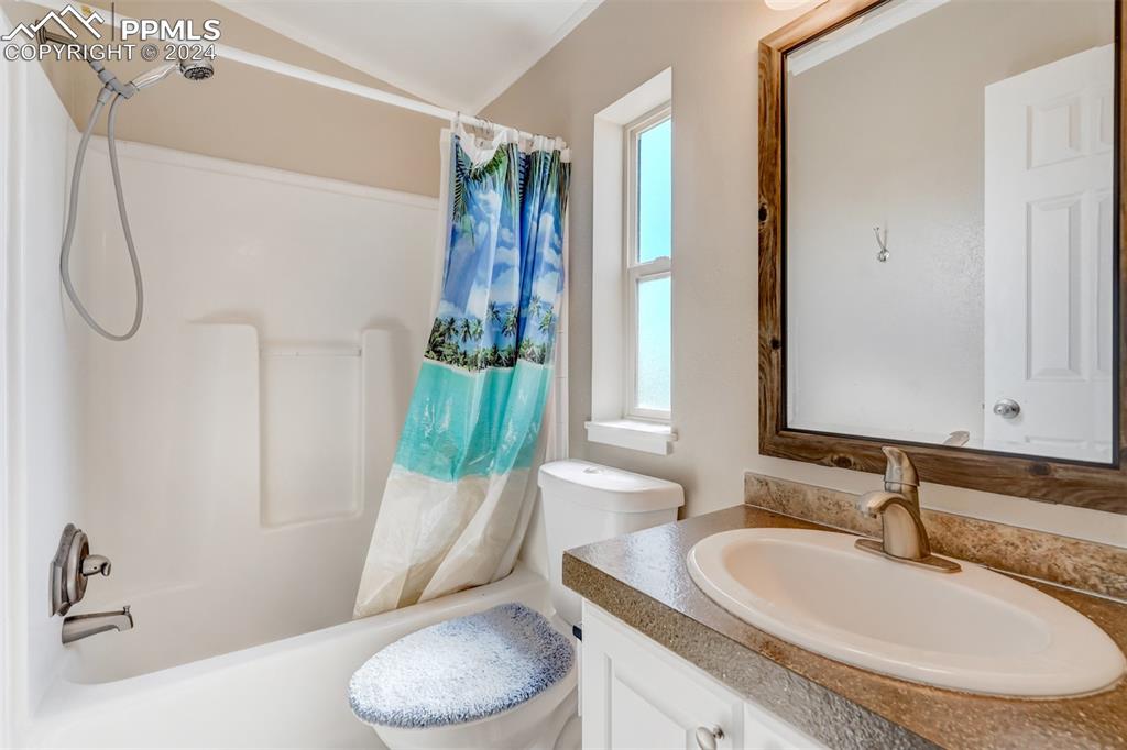 6240 Night Train Lane Yoder, CO 80864 - Photo 37 of 50 a bathroom with a granite countertop sink and a mirror