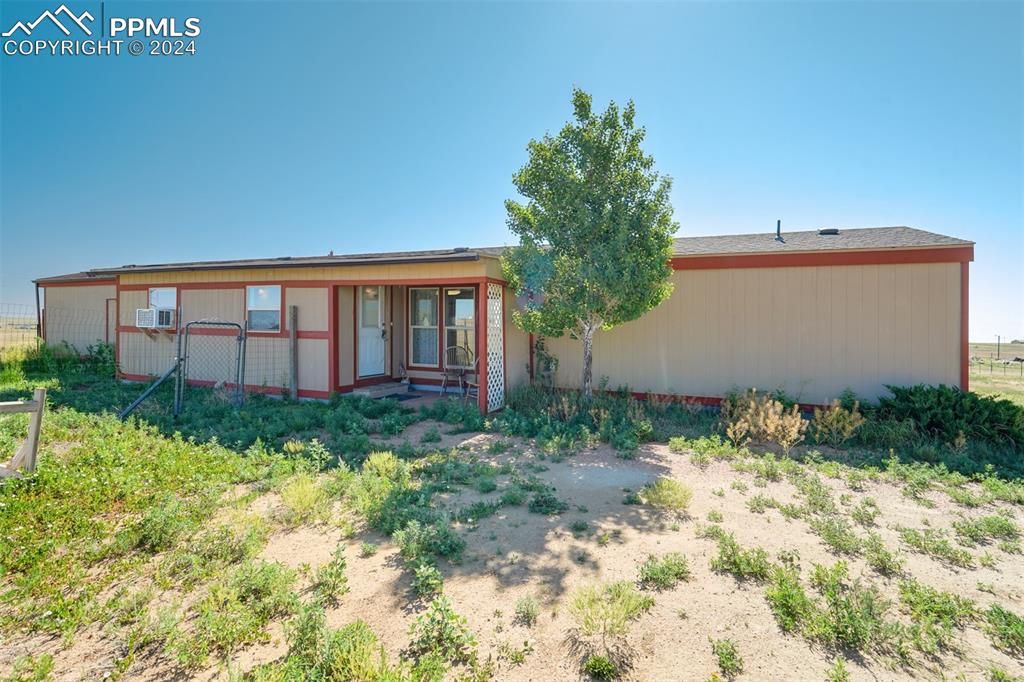 6240 Night Train Lane Yoder, CO 80864 - Photo 40 of 50 a backyard of a house with lots of green space and garden view